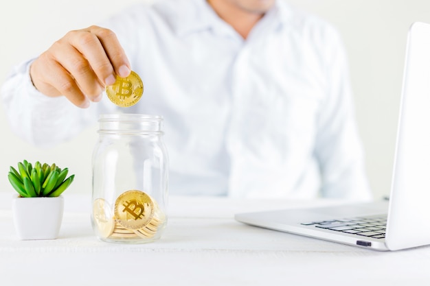 Bitcoin coin golden coin in the glass jar on wooden 