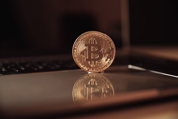 Bitcoin coin symbol on laptops keyboard future financial currency concept