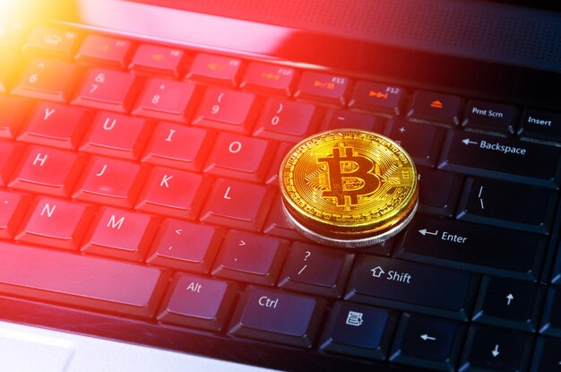 Bitcoin coins on compuer keyboardsymbol of electronic virtual money and mining cryptocurrency conceptCoin crypto currency bitcoin conceptBitcoin on keyboard