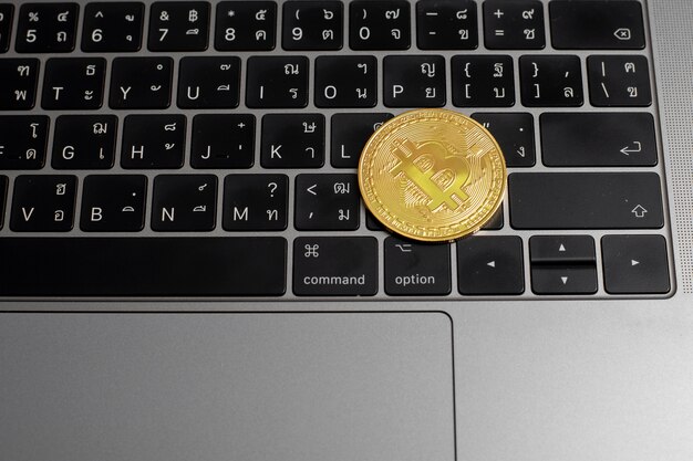 Bitcoin coins on a laptop keyboard