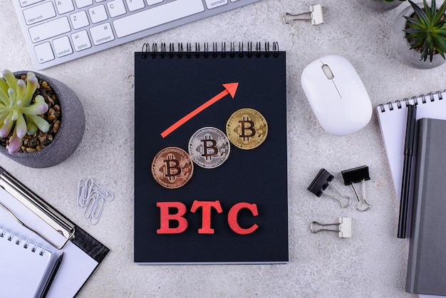 Bitcoin coins on office desk cryptocurrency concept