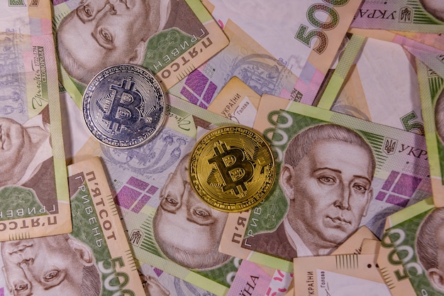 Bitcoin coins on the ukrainian five hundred hryvnas banknotes