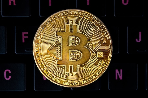 Bitcoin on compuer keyboard in surface, symbol of electronic virtual money and mining cryptocurrency concept