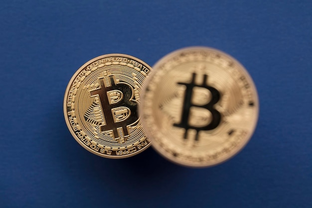 Bitcoin cryptocurrency blockchain gold coins on a blue background