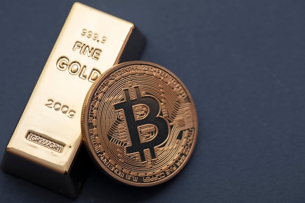 Bitcoin cryptocurrency coin with a gold bullion bar investment concept