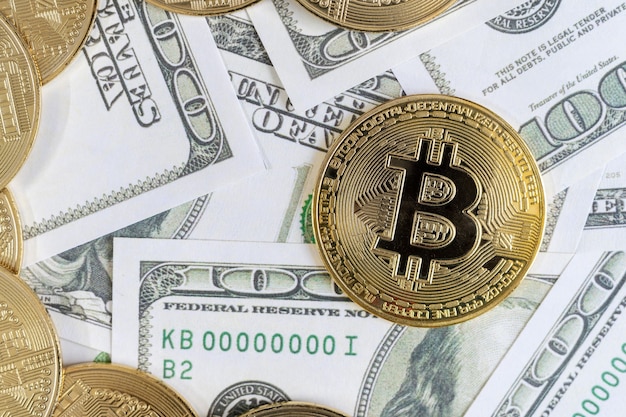 Bitcoin cryptocurrency golden coins and dollar bill in background