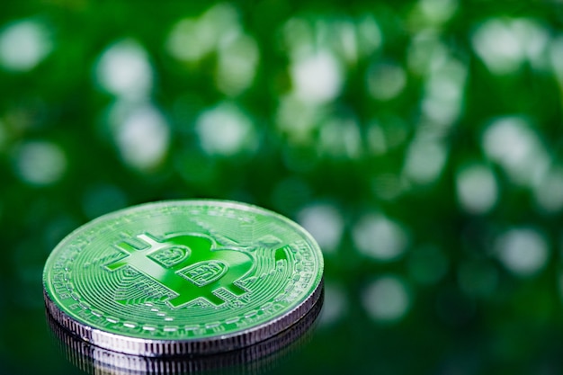 Bitcoin digital currency on green blurred bokeh background