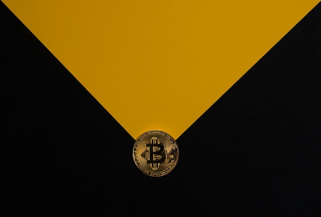 Bitcoin gold coin on black banner with copy space for text and yellow light ray cryptocurrency and c...