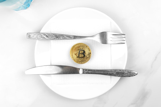 Bitcoin gold coin concept Cryptocurrency mixed media image Served bitcoin on a white plate Marble background photo