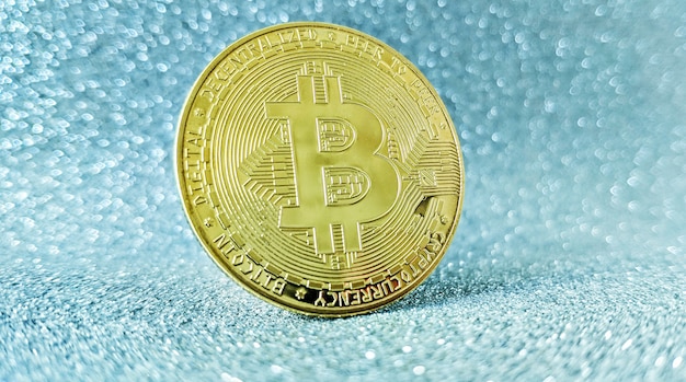 Bitcoin gold coin and defocused glitter background