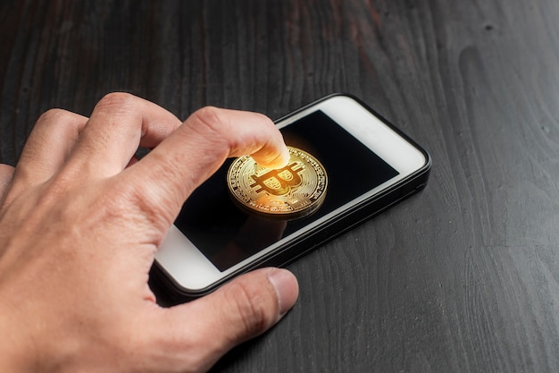 Bitcoin gold on the Smartphone. new cryptocurrency concept