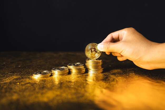 Bitcoin growth,bitcoin coins stacked on black gold background