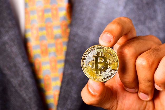 Bitcoin in hand of business man with suit