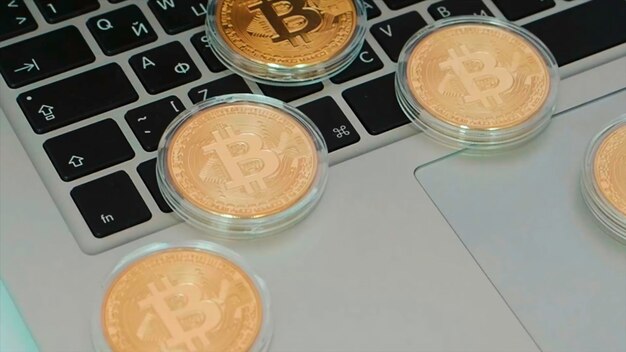 Bitcoin on laptop keyboard stock bitcoin coin close up with laptop in background cryptocurrency