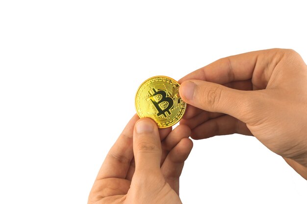 Bitcoin in male hands isolated on the white background, person gives cryptocurrency golden coin concept photo