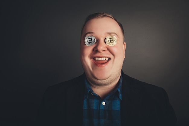 Bitcoin male lover with golden coin on his eyes