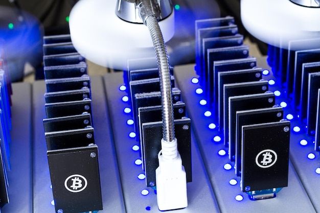 Photo bitcoin mining usb devices in a row with small fans.