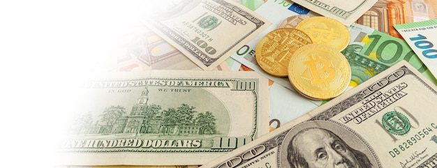 Bitcoins on a texture background of euro and dollars panorama