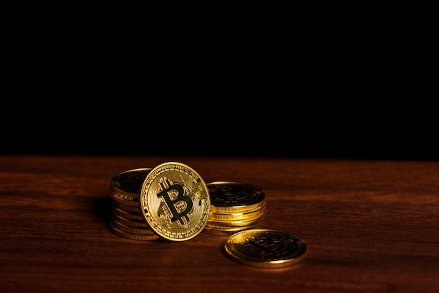 Photo bitcoins on wooden desk.