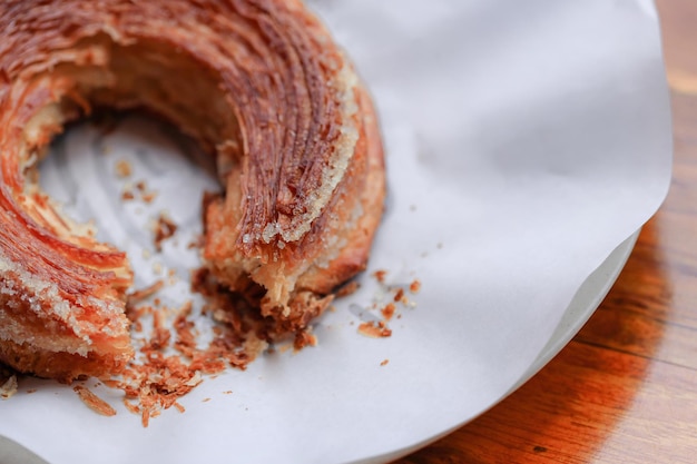 A bite of croissant on white plate