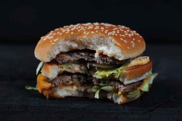 Bitten burger on a dark rustic