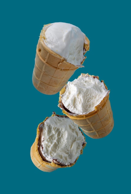 Bitten ice cream in waffle cups flies on a blue background