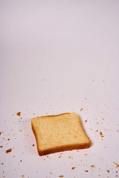 Bitten slice of toast bread on a white isolated background.