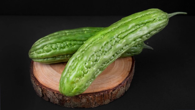 Bitter Gourd on a Wooden Coaster