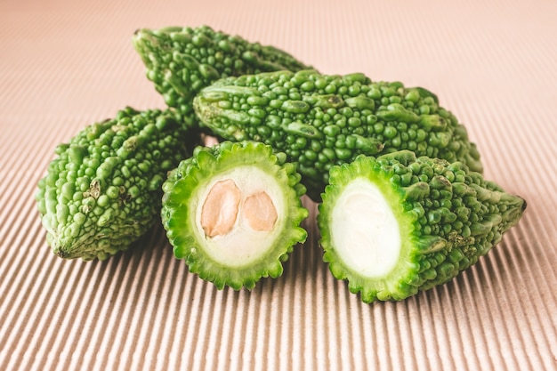 Bitter melon or bitter gourd on wooden background. 