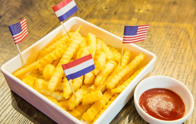 Bitterballen Dutch meatbased snack in white plate with Netherlands flags served with yellow mustard Typically containing a mixture of beef or veal Bitterball are one of Hollands favorite snacks