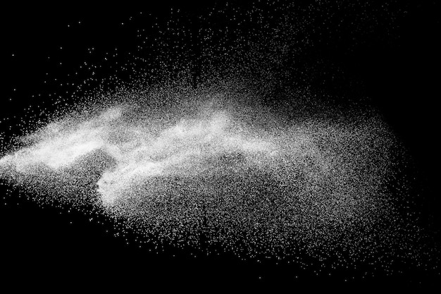 Photo bizarre forms of white powder explosion cloud against black background.white dust particles splash.