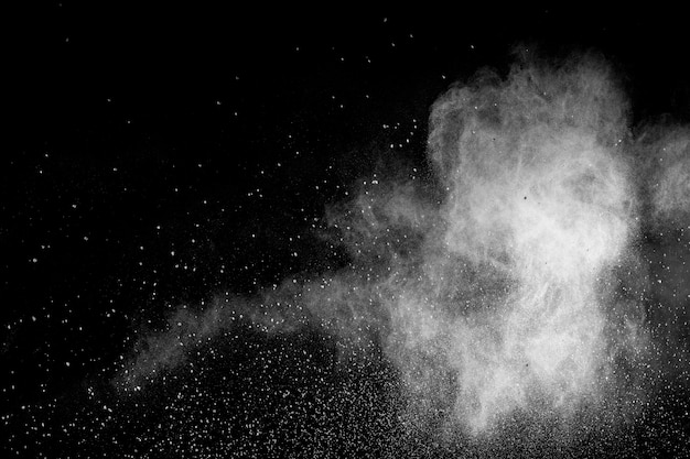 Bizarre forms of white powder explosion cloud against black background.White dust particles splash.