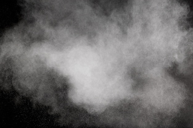 Photo bizarre forms of white powder explosion cloud against black background.