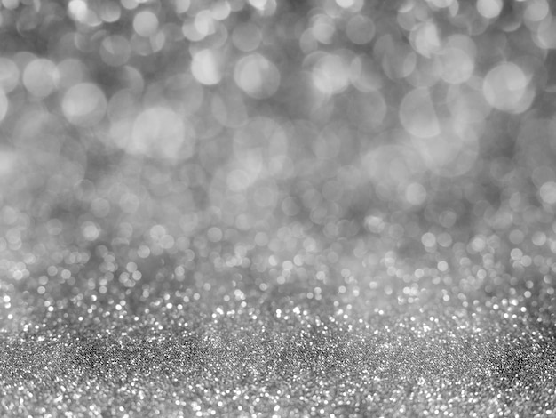 Black abstract glitter background with bokeh.