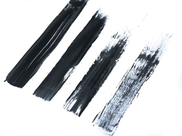 Photo black acrylic paint stroke isolated on white background abstract art concept