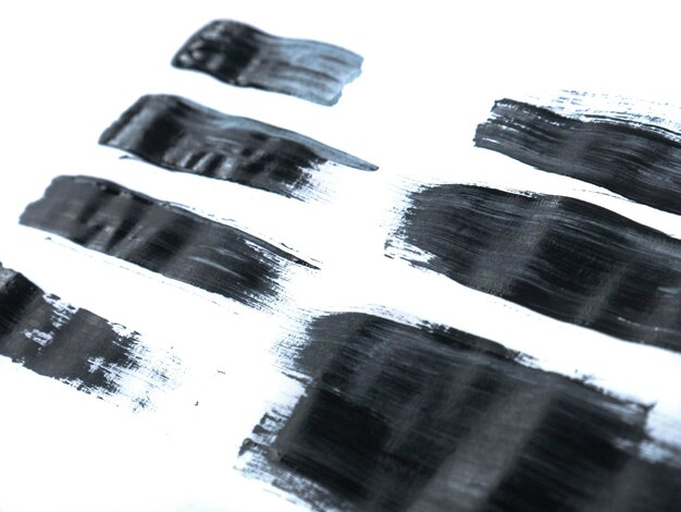 Photo black acrylic paint stroke isolated on white background abstract art concept