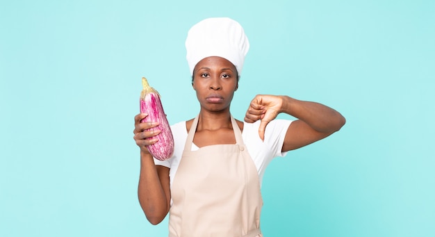 black african american adult chef woman holding an eggplant