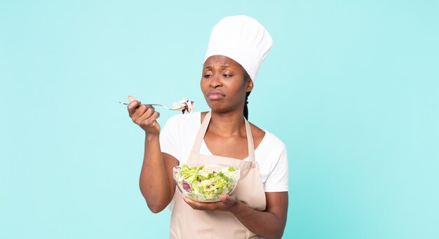 Black african american adult chef woman holding a salad