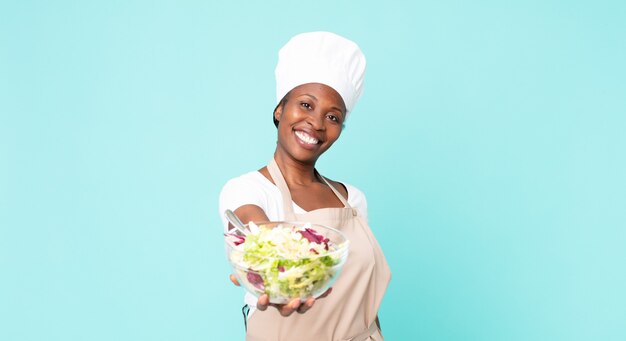 black african american adult chef woman holding a salad