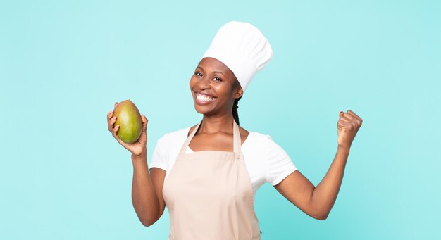 Black african american adult chef woman hwith a mango