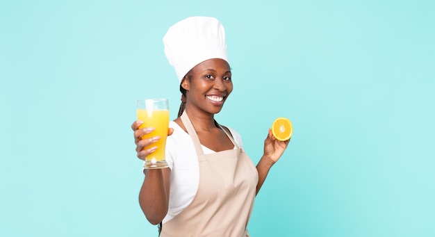 Black african american adult chef woman . orange juice concept