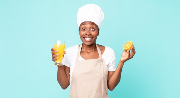 Black african american adult chef woman . orange juice concept