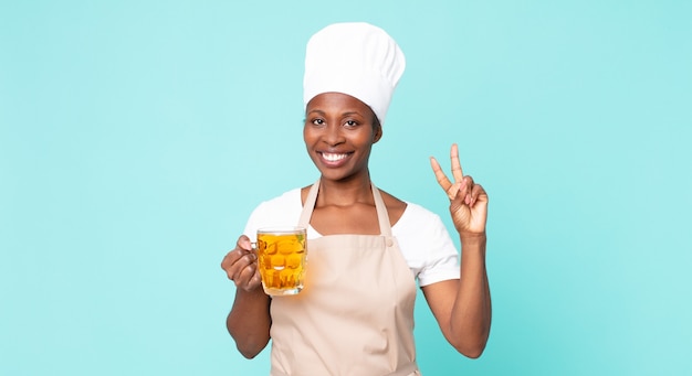 Black african american adult chef woman with a pint beer