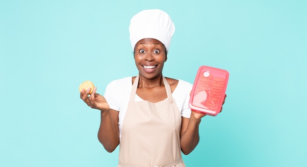 Black african american adult chef woman with a tupperware