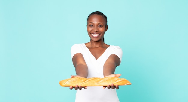 black african american adult woman holding a baguette