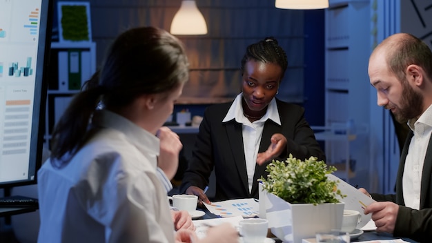 Black african american manager brainstorming strategy ideas analyzing management paperwork