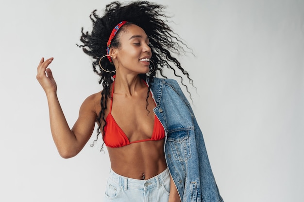 black african american woman in stylish hipster outfit denim jacket and jeans on white