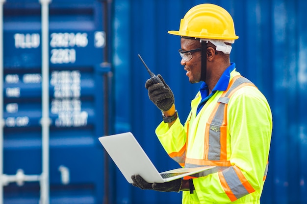 Black African happy worker working in logistic communication using radio