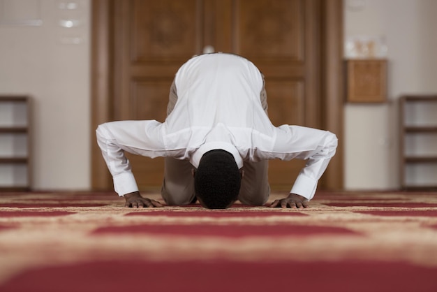 Black African Muslim Man Is Praying In The Mosque