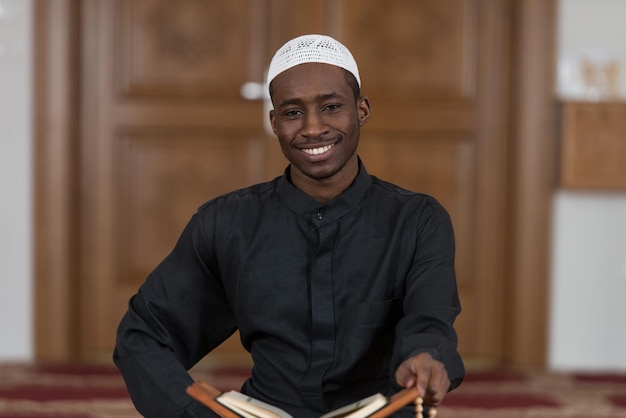 Black African Muslim Man Reading Holy Islamic Book Koran